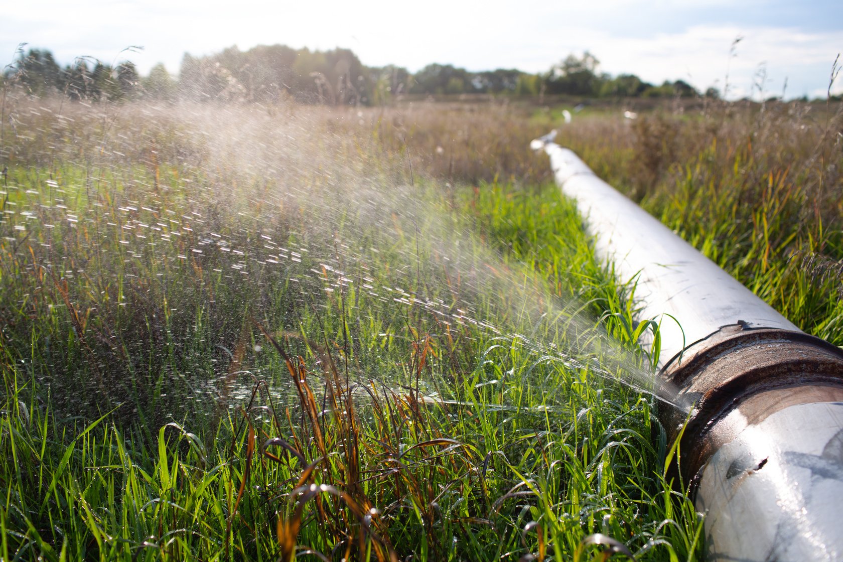 Leaking Water Pipe with Jet from Hole at Outdoor Field